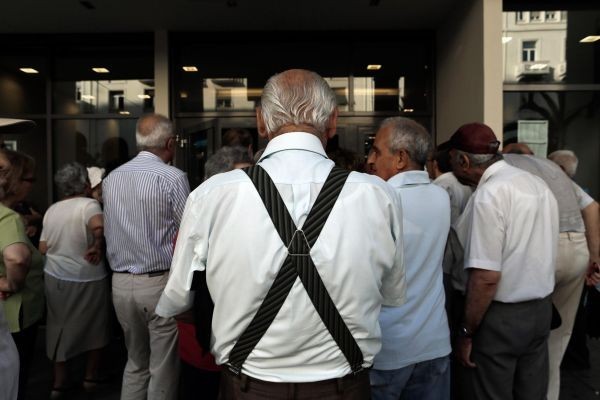 Pensioners queue outside a Eurobank branch as wait to collect their pensions, in Thessaloniki, Greece on July 20, 2015.