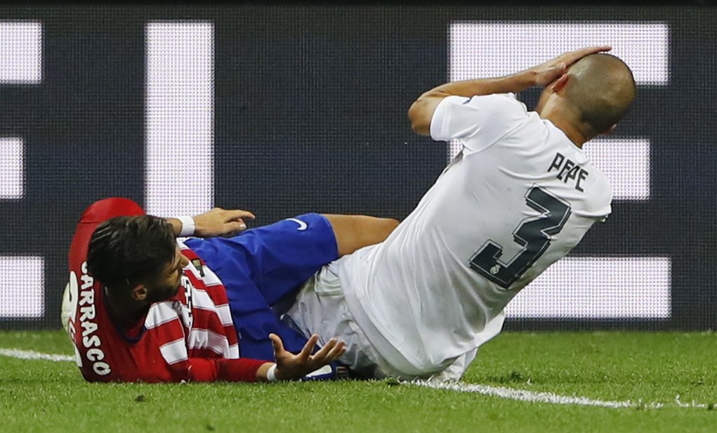 Soccer Football - Atletico Madrid v Real Madrid - UEFA Champions League Final - San Siro Stadium, Milan, Italy - 28/5/16 Atletico Madrid's Yannick Ferreira Carrasco has a clashing with Real Madrid's Pepe and is later stretchered off with a injury Reuters / Stefan Wermuth Livepic EDITORIAL USE ONLY.