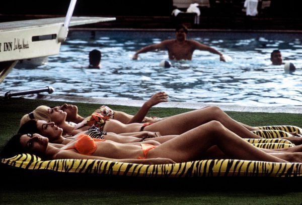USA. Las Vegas, Nevada. Four sunbathers on leopard skin-printed rafts. 1968.