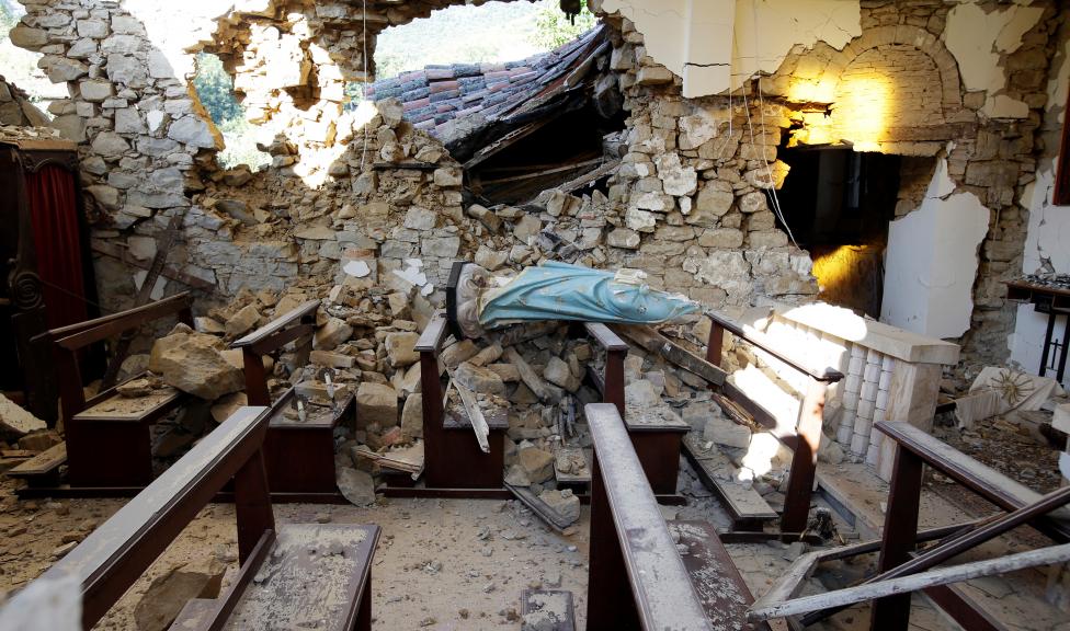 A damaged Virgin Mary statue is seen in a church following an earthquake at Cossito. REUTERS/Max Rossi