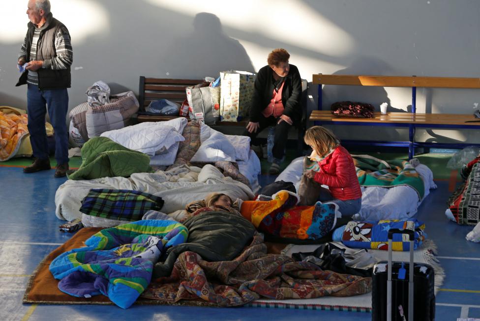 People rest following an earthquake in Amatrice, central Italy. REUTERS/Ciro De Luca