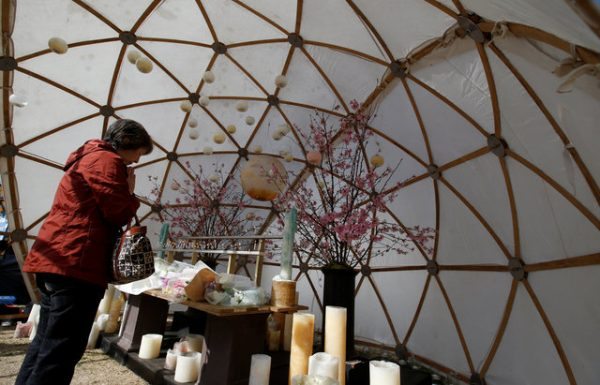 A woman prays for victims of the March 11, 2011 earthquake and tsunami disaster, at a park in Tokyo, Japan, March 11, 2017, to mark the sixth-year anniversary of the disaster that killed thousands and set off a nuclear crisis. REUTERS/Toru Hanai