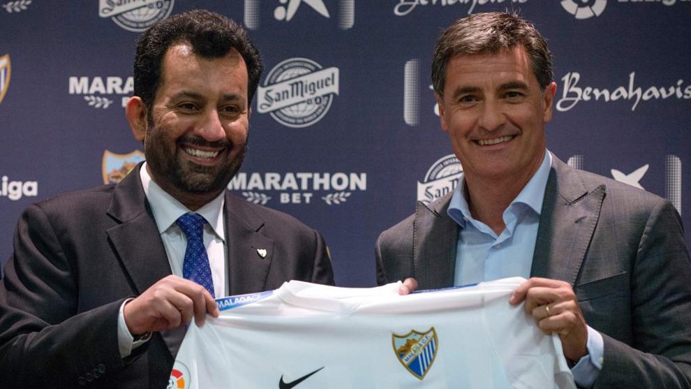 Malaga's new coach Jose Miguel Gonzalez Martin del Campo aka Michel (R) poses with Malaga CF's chairman Sheikh Abdallah Ben Nasser Al-Thani during his official presentation at the Rosaleda stadium in Malaga, on March 8, 2017. / AFP PHOTO / JORGE GUERRERO