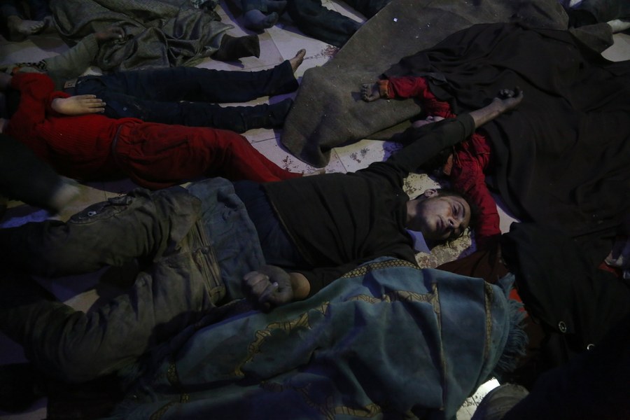 epa06655170 Bodies of victims of alleged chemical attack lie on the ground in rebels-held Douma, Syria, 08 April 2018. According to media and local reports, at least 70 people died after a helicopter dropped a barrel bomb allegedly containing Sarin gas, a nerve toxin that kills within minutes of direct inhalation unless treated quickly with an antidote. Locals claim that the helicopter allegedly belongs to forces loyal to the Syrian government, while both Syria and Russia denied using chemical weapons and called the attack a fabrication by Jayesh al-Islam (the military ruler of Douma) in an attempt to hinder the Syrian Arab Army advancement, according to a report on the Syrian Arab News Agency, the Syrian Government's official news agency. EPA/EMAD ALDIN ATTENTION: GRAPHIC CONTENT