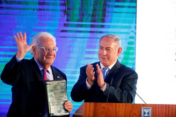 Israeli Prime Minister Benjamin Netanyahu claps after handing U.S. Ambassador to Israel David Friedman a letter of appreciation, during a reception held at the Israeli Ministry of Foreign Affairs in Jerusalem, ahead of the moving of the U.S. embassy to Jerusalem, May 13, 2018. REUTERS/Amir Cohen