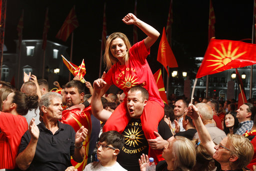 Supporters of the opposition VMRO-DPMNE party protest in front of the Government building in Skopje, Macedonia, Saturday, June 2, 2018. Tens of thousands of main Macedonian conservative opposition party supporters have gathered late on Saturday for anti-government protest in front of the country's government building in downtown of the Macedonian capital Skopje. (AP Photo/Boris Grdanoski)