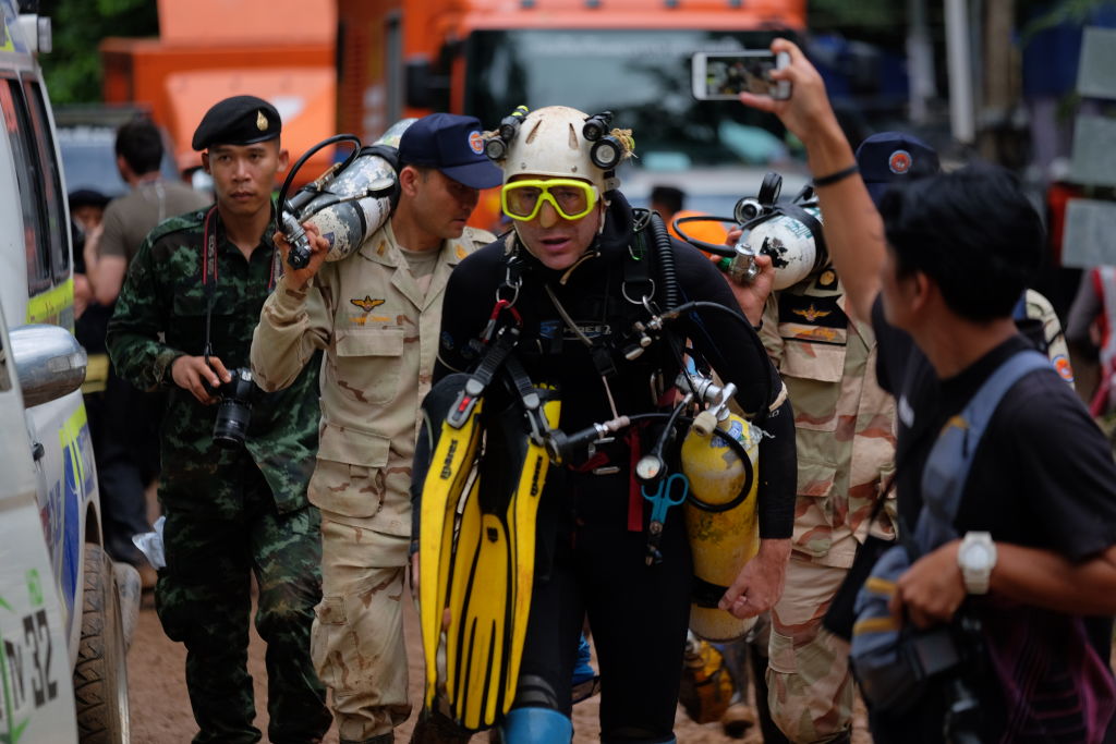 CHIANG RAI, THAILAND - JUNE 28: British cave-diver John Volanthen walks out from Tham Luang Nang Non cave in full kit without any response to reporter's questions on June 28, 2018 in Chiang Rai, Thailand. Rescuers battled heavy rain in northern Thailand as they continued the search for 12 boys and their soccer coach who have been missing in Tham Luang Nang Non cave since Saturday night after monsoon rains blocked the main entrance. Teams of Navy SEAL divers worked their way through submerged passageways in the sprawling underground caverns as senior Thai government officials warned on Wednesday that time is running out and the search intensifies for the young soccer team, aged between 11 to 16, and their their 25-year-old coach, with soldiers and park rangers seeking other entry points into the cave system. (Photo by Linh Pham/Getty Images)