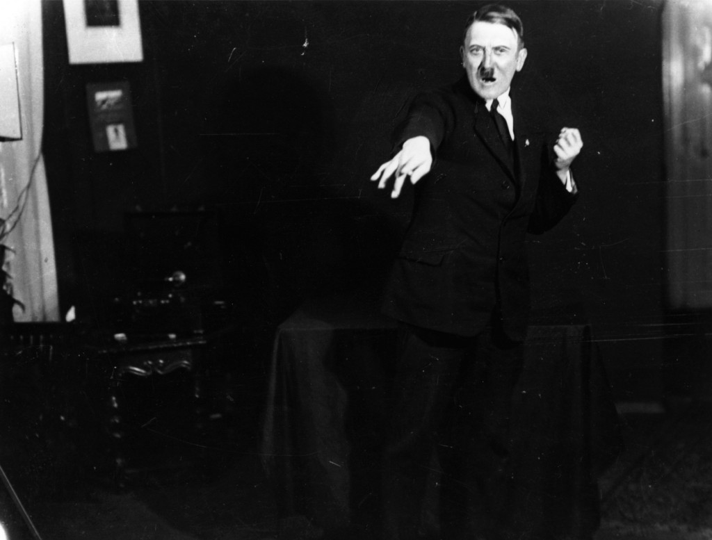1925:  Adolf Hitler (1889 - 1945), leader of the National Socialist German Workers' Party (NSDAP), strikes a pose for photographer Heinrich Hoffmann whilst listening to a recording of his own speeches. After seeing the photographs, Hitler ordered Hoffmann to destroy the negatives, but he disobeyed.  (Photo by Heinrich Hoffmann/Keystone Features/Getty Images)