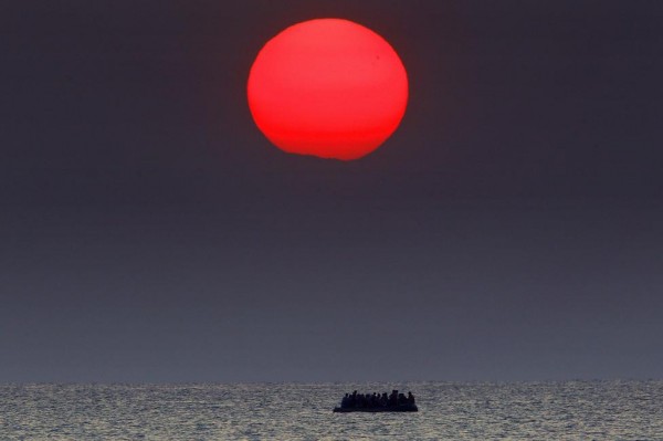Syrian refugees on a dinghy drift in the Aegean sea off the Greek island of Kos in Greece