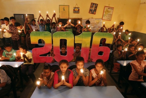 School students offer prayers for the world peace in the upcoming year of 2016 in Ahmedabad, India, December 31, 2015. REUTERS/Amit Dave