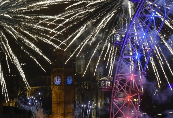 Fireworks explode around the London Eye wheel, the Big Ben clock tower and the Houses of Parliament to mark the beginning of the New Year in London, Britain, January 1, 2016. REUTERS/Toby Melville