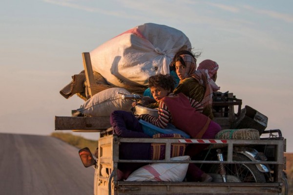Residents return to their villages on a pickup truck after YPG fighters said that they retook control of the area from IS in the southern countryside of Ras al-Ain