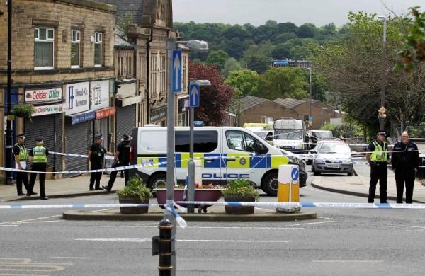 Police stand behind a cordon in Birstall near Leeds