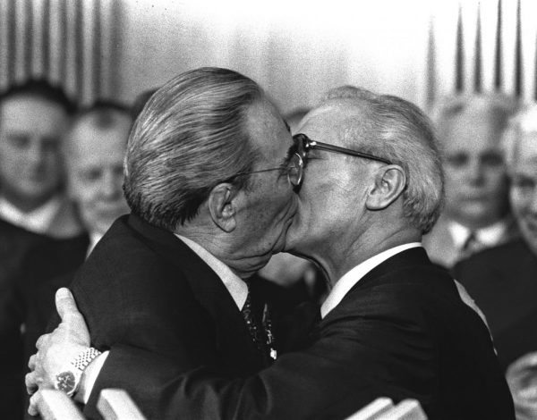 Soviet President Leonid Brezhnev and East German leader Erich Honecker change kisses, 1979