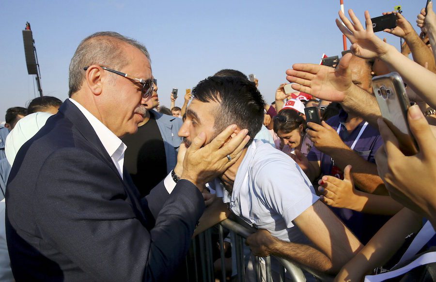 Turkey's President Tayyip Erdogan holds a head of the man as he attends the Democracy and Martyrs Rally, organized by him and supported by ruling AK Party (AKP), oppositions Republican People's Party (CHP) and Nationalist Movement Party (MHP), to protest against last month's failed military coup attempt, in Istanbul, Turkey, August 7, 2016. Kayhan Ozer/Presidential Palace/Handout via REUTERS FOR EDITORIAL USE ONLY. NOT FOR SALE FOR MARKETING OR ADVERTISING CAMPAIGNS. THIS IMAGE HAS BEEN SUPPLIED BY A THIRD PARTY. IT IS DISTRIBUTED, EXACTLY AS RECEIVED BY REUTERS, AS A SERVICE TO CLIENTS.