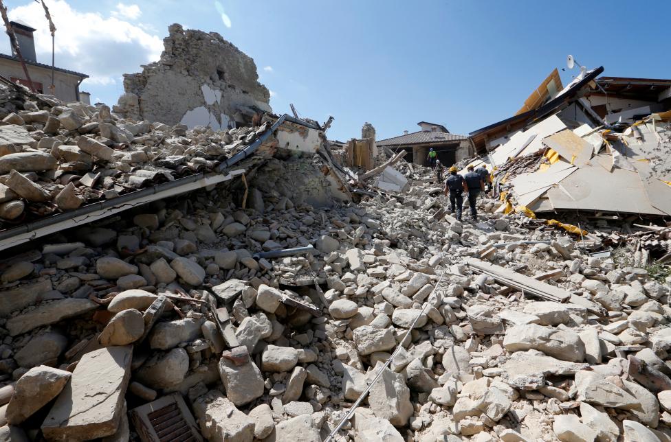 Rescuers work on collapsed buildings following an earthquake in Amatrice, central Italy. REUTERS/Ciro De Luca