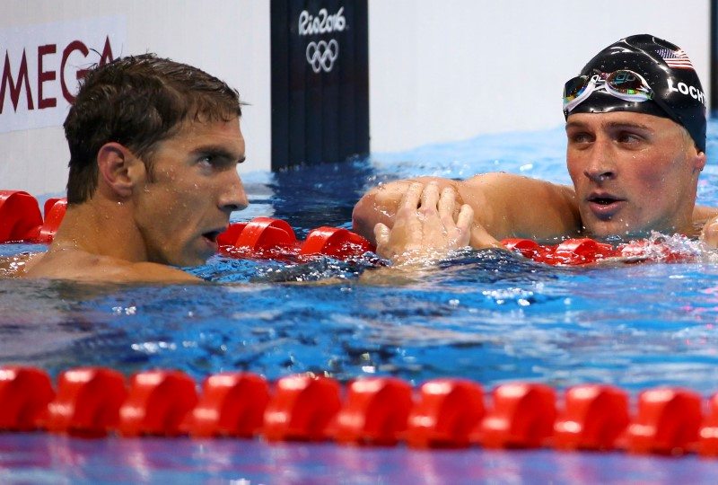 Michael Phelps reacts next to teammate Ryan Lochte after winning. REUTERS/David Gray