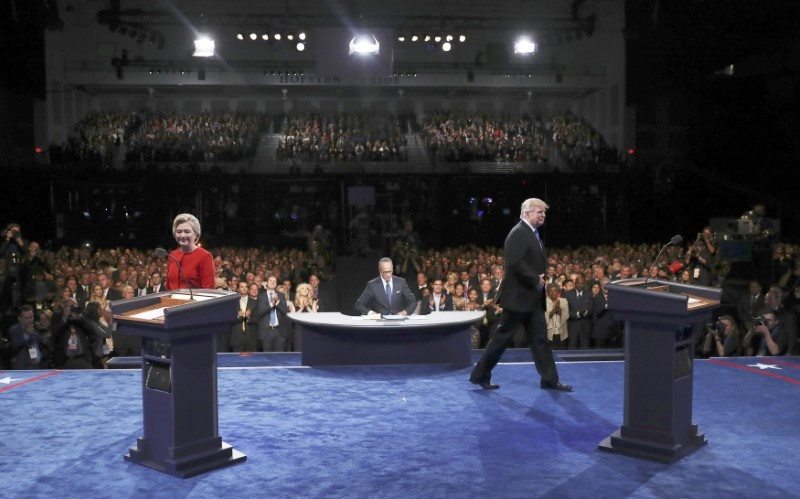 Republican U.S. presidential nominee Donald Trump and Democratic U.S. presidential nominee Hillary Clinton walk on the stage during their first presidential debate at Hofstra University in Hempstead, New York, U.S., September 26, 2016. REUTERS/Pool