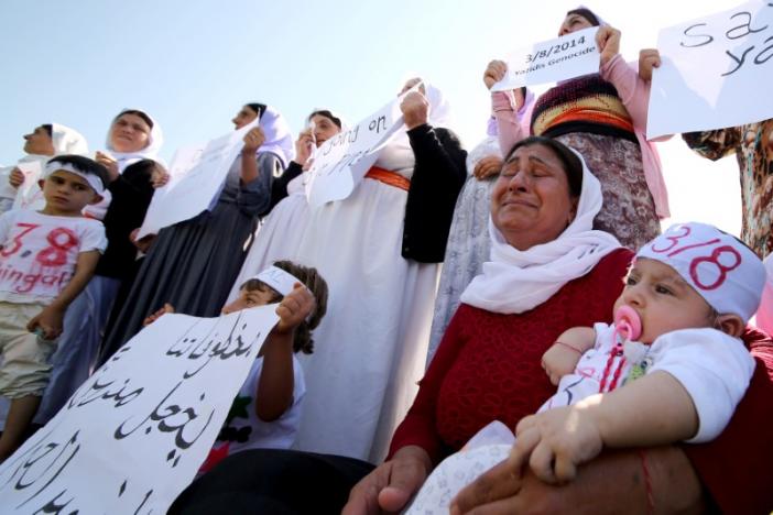 Yazidi women cry as they attend a demonstration at a refugee camp in Kurdish-dominated city of Diyarbakir, Turkey, to mark the second anniversary of what a U.N.-appointed commission of independent war crimes investigators termed a genocide against the Yazidi population by the Islamic State, August 3, 2016. REUTERS/Sertac Kayar