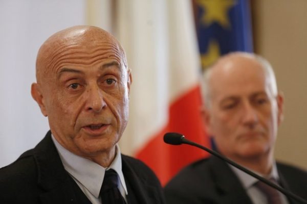 Italian Interior Minister Marco Minniti (L) and cheif of police Franco Gabrielli attend a news conference in Rome, Italy, to announce that the suspect in the Berlin truck attack was killed in a shoot-out in a suburb of the norhtern Italian city of Milan, December 23, 2016. REUTERS/Alessandro Bianchi