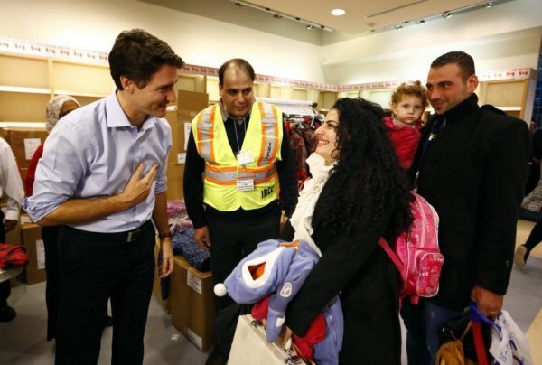 Syrian refugees are greeted by Canada's Prime Minister Justin Trudeau on their arrival from Beirut at the Toronto Pearson International Airport in Mississauga, Ontario, December 11, 2015. REUTERS/Mark Blinch