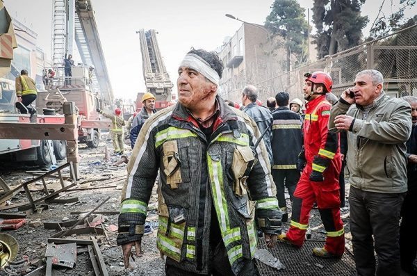 A wounded firefighter stands at the site of a collapsed high-rise building in Tehran, Iran January 19, 2017. Tasnim News Agency/Handout via REUTERS ATTENTION EDITORS - THIS PICTURE WAS PROVIDED BY A THIRD PARTY. FOR EDITORIAL USE ONLY. NO RESALES. NO ARCHIVE.