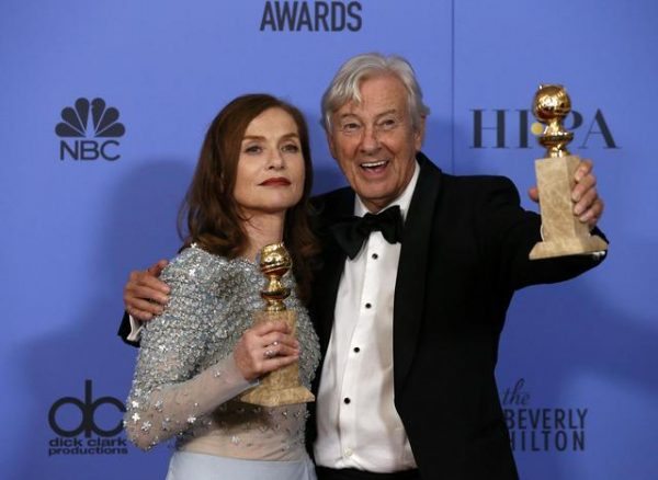 Actress Isabelle Hubbert and producer Paul Verhoeven pose backstage with their awards for Best Actress in a Motion Picture - Drama and Best Motion Picture - Foreign Language for "Elle," at the 74th Annual Golden Globe Awards in Beverly Hills, California, U.S., January 8, 2017. REUTERS/Mario Anzuoni