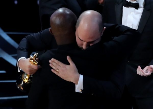 89th Academy Awards - Oscars Awards Show - Hollywood, California, U.S. - 26/02/17 - Barry Jenkins of "Moonlight" (L) embraces Jordan Horowitz of "La La Land" after the presentation of the Oscar for Best Picture was corrected and given to "Moonlight." REUTERS/Lucy Nicholson