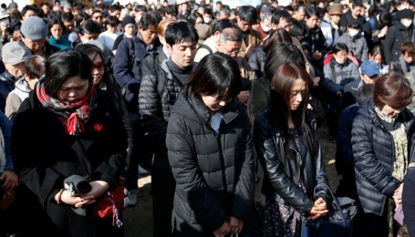 Participants observe a moment of silence at 2:46 p.m. (0546 GMT), the time when the magnitude 9.0 earthquake struck off Japan's coast in 2011, during a rally in Tokyo, March 11, 2017, to mark the sixth-year anniversary of the earthquake and tsunami that killed thousands and set off a nuclear crisis. REUTERS/Toru Hanai
