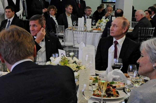 FILE PHOTO: Russian President Vladimir Putin (R) sits next to retired U.S. Army Lieutenant General Michael Flynn (L) as they attend an exhibition marking the 10th anniversary of RT (Russia Today) television news channel in Moscow, Russia, December 10, 2015. Picture taken December 10, 2015. Sputnik/Mikhail Klimentyev/Kremlin via REUTERS/File Photo ATTENTION EDITORS - THIS IMAGE WAS PROVIDED BY A THIRD PARTY. EDITORIAL USE ONLY.