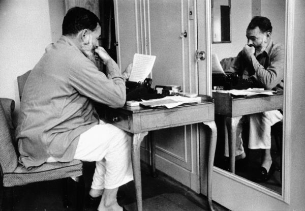 EH4475P nd. Ernest Hemingway seated at a desk with typewriter during World War II. Copyright Unknown in the Ernest Hemingway Collection at the John F. Kennedy Presidential Library and Museum, Boston.