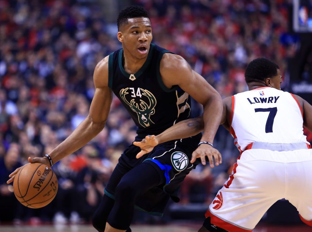 TORONTO, ON - APRIL 15: Giannis Antetokounmpo #34 of the Milwaukee Bucks dribbles the ball as Kyle Lowry #7 of the Toronto Raptors defends in the first half of Game One of the Eastern Conference Quarterfinals during the 2017 NBA Playoffs at Air Canada Centre on April 15, 2017 in Toronto, Canada. NOTE TO USER: User expressly acknowledges and agrees that, by downloading and or using this photograph, User is consenting to the terms and conditions of the Getty Images License Agreement. (Photo by Vaughn Ridley/Getty Images)