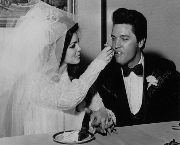 Elvis Presley (1935 - 1977) being fed a mouthful of wedding cake by his bride Priscilla Beaulieu at the Aladdin Hotel, Las Vegas. (Photo by Keystone/Getty Images)