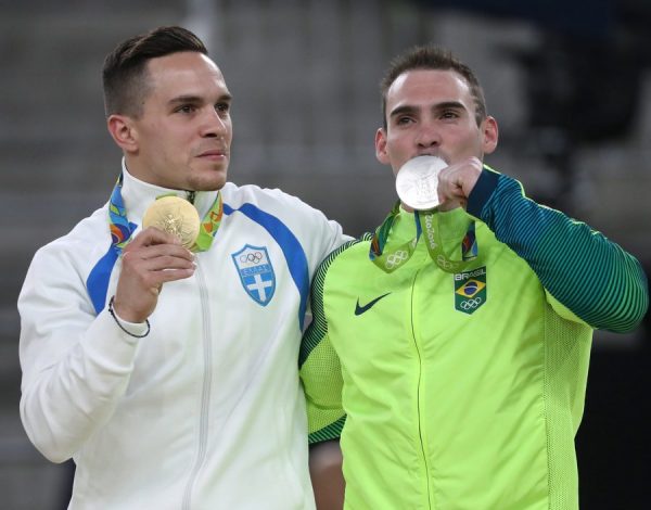 epa05487209 Gold medalist Eleftherios Petrounias (L) of Greece and silver medalist Arthur Zanetti (R) of Brazil pose during the award ceremony of the men's Rings final for the Rio 2016 Olympic Games Artistic Gymnastics events at the Rio Olympic Arena in Barra da Tijuca, Rio de Janeiro, Brazil, 15 August 2016. EPA/HOW HWEE YOUNG