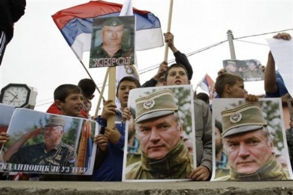 Bosnian Serb people holding Serbian flags and photos of former Gen. Ratko Mladic during a protest in Kalinovik, Bosnia, hometown of the Bosnian Serb wartime military leader, 70 kms southeast of Sarajevo, Sunday, May 29, 2011. Approximately 3,000 Bosnian Serbs, gathered to show support and anger after the arrest of Mladic. Protestors carried banners and flags and sang songs in his support, he was arrested after 16 years in hiding from the International War Crimes Tribunal in the Hague. Mladic is to face trial on 15 accounts of war crimes including genocide in Srebrenica in 1995. (AP Photo/Amel Emric)