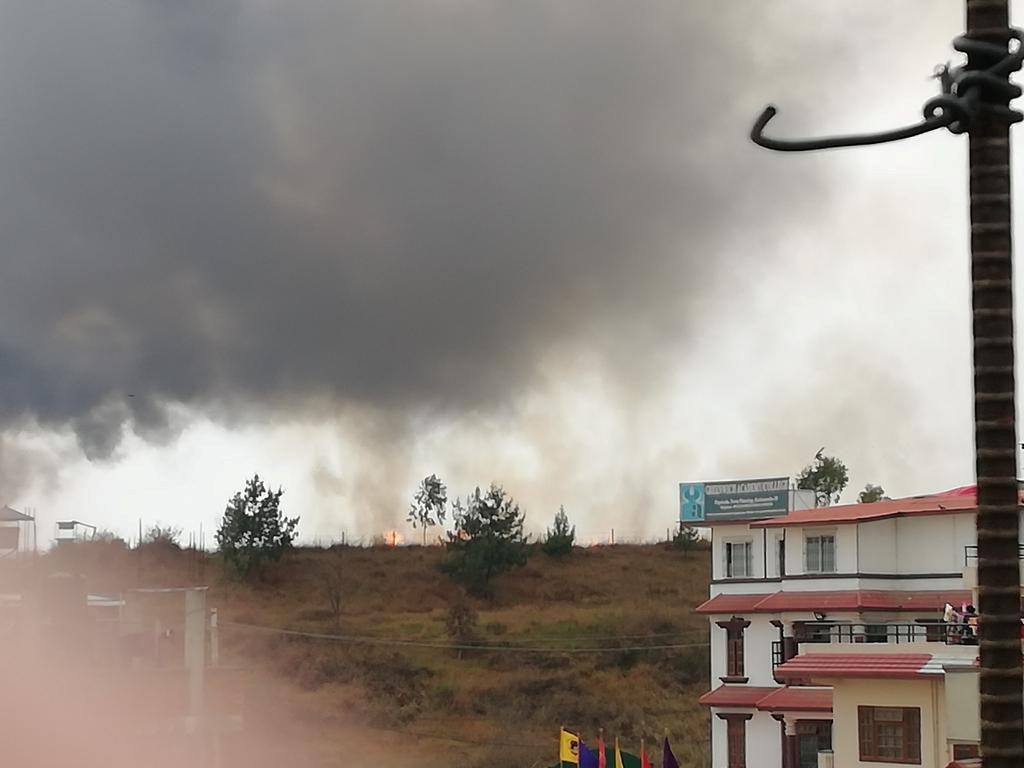 Smoke rises following the crash of a Bangladeshi aircraft at Kathmandu airport, Nepal March 12, 2018 in this picture obtained from social media. RUSHA GIRI/via REUTERS THIS IMAGE HAS BEEN SUPPLIED BY A THIRD PARTY. MANDATORY CREDIT. NO RESALES. NO ARCHIVES. MUST ON SCREEN COURTESY RUSHA GIRI.