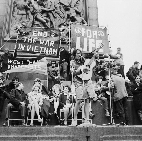 American folk singer Joan Baez performs at an anti-Vietnam War demonstration in London's Trafalgar Square, 29th May 1965. Amongst her audience are actress Vanessa Redgrave and singer Donovan. (Photo by Keystone/Hulton Archive/Getty Images)