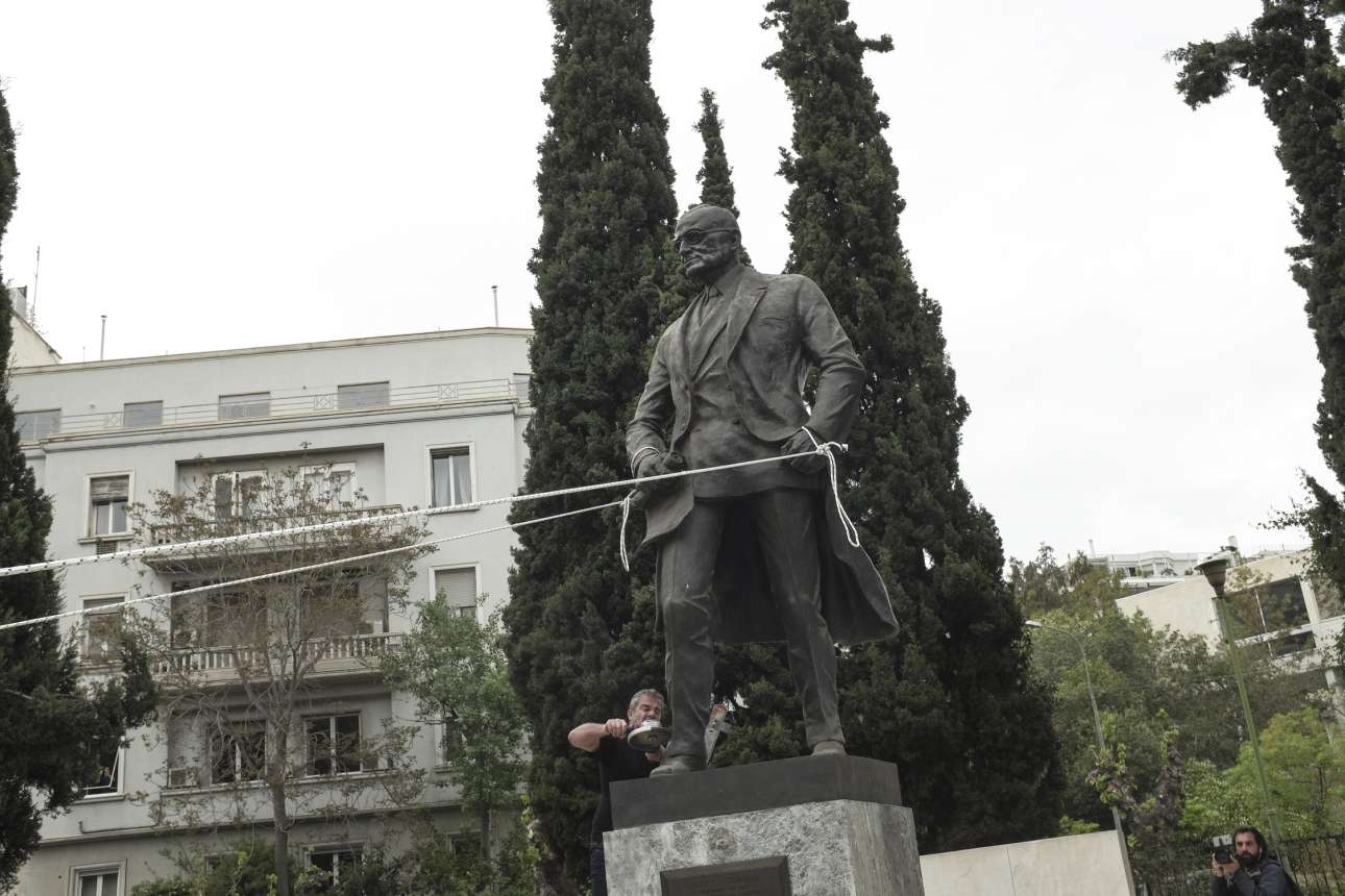 Δευτέρα, 16 Απριλίου, Ελλάδα. Ενας διαδηλωτής διακρίνεται να επιχειρεί να πριονίσει το πόδιο του αγάλματος του Χάρι Σ. Τρούμαν, το οποίο άλλοι με σκοινιά προσπαθούν να γκρεμίσουν, κατά τη διάρκεια αντιπολεμικού συλαλλητηρίου στο κέντρο της Αθήνας